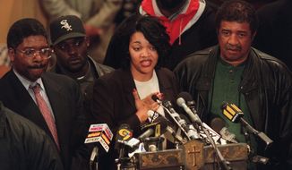 ** FILE ** Tawana Brawley speaks to supporters at Bethany Baptist Church in the Brooklyn borough of New York on Dec. 2, 1997. She is flanked by Alton Maddox (left) and her stepfather Ralph King (right). In 1987, Brawley&#39;s allegations of a racially charged rape became a national flashpoint. (Associated Press)
