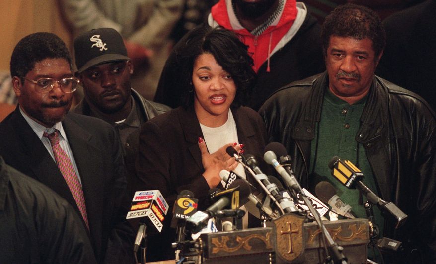 ** FILE ** Tawana Brawley speaks to supporters at Bethany Baptist Church in the Brooklyn borough of New York on Dec. 2, 1997. She is flanked by Alton Maddox (left) and her stepfather Ralph King (right). In 1987, Brawley's allegations of a racially charged rape became a national flashpoint. (Associated Press)