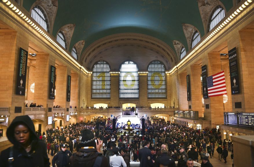 Crowds gather as Grand Central Terminal kicks off its centennial celebration on Friday, Feb. 1, 2013, in New York. New Yorkers are celebrating the 100th birthday of Grand Central terminal with music, speeches and a cake shaped like the main concourse's famous clock. (AP Photo/Bebeto Matthews)