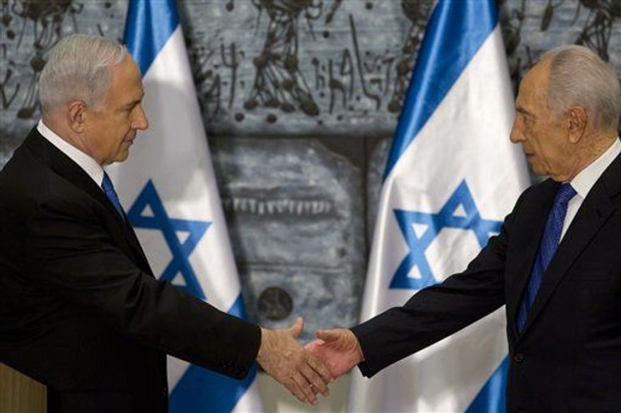 Israeli Prime Minister Benjamin Netanyahu, left, shakes hands with Israeli President Simon Peres during a brief ceremony in the president' Jerusalem residence Saturday Feb. 2, 2013. (Associated Press)