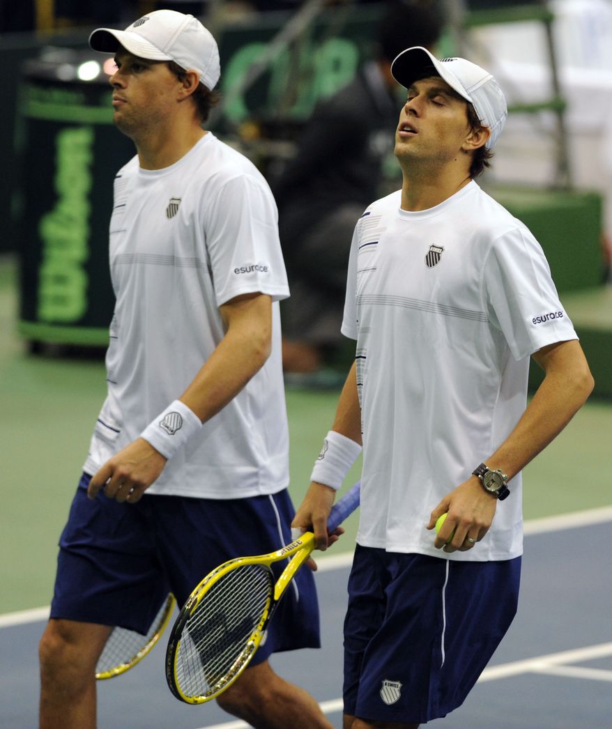 The United States' Bob Bryan, left, and Mike Bryan struggle in the fifth set after having their serve broken against Brazil's Marcelo Melo and Bruno Soares during their Davis Cup doubles tennis match in Jacksonville, Fla. on Saturday Feb. 2, 2013. (AP Photo/The Florida Times-Union, Bob Mack)