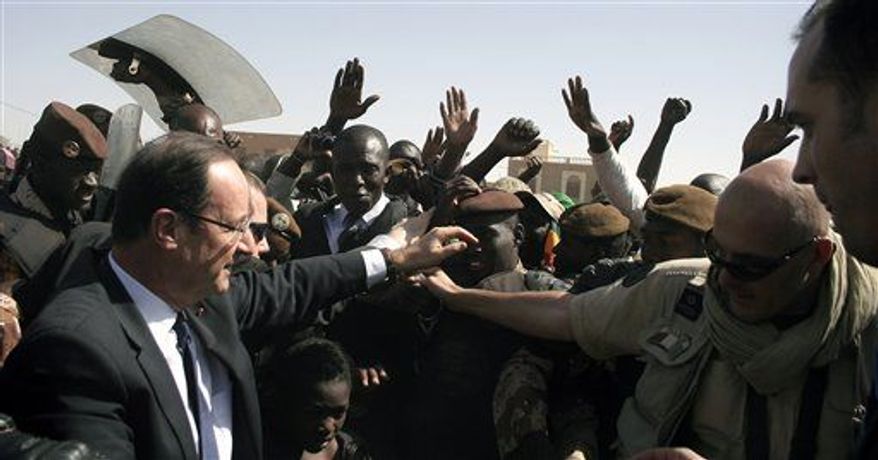 French President Francois Hollande visits Timbuktu, Mali, Saturday Feb. 2, 2013. Hollande indicated Friday that during his visit to the former French colony, he would discuss the reduction of French troop levels on the ground to make way for an African force, led by Mali. (Associated Press)
