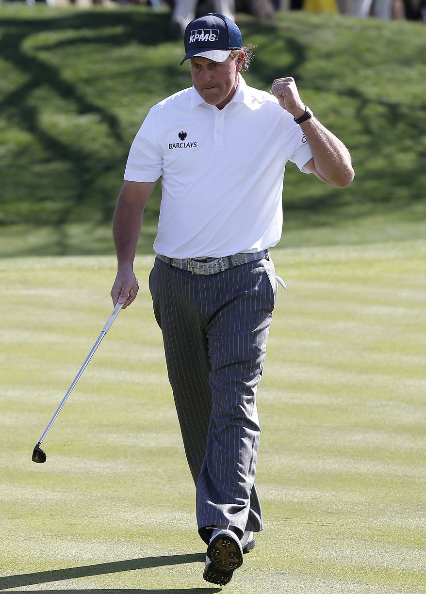 Phil Mickelson reacts to his birdie putt on the first green during the third round of the Waste Management Phoenix Open golf tournament, Saturday, Feb. 2, 2013, in Scottsdale, Ariz. (AP Photo/Matt York)