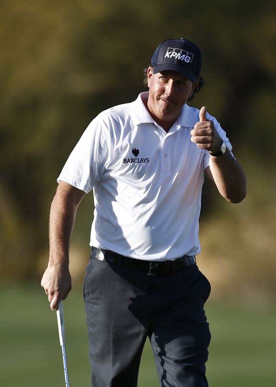 Phil Mickelson gives a thumbs-up to the crowd after making an eagle on the 15th hole during the second round of the Waste Management Phoenix Open golf tournament on Friday, Feb. 1, 2013, in Scottsdale, Ariz. (AP Photo/Ross D. Franklin)