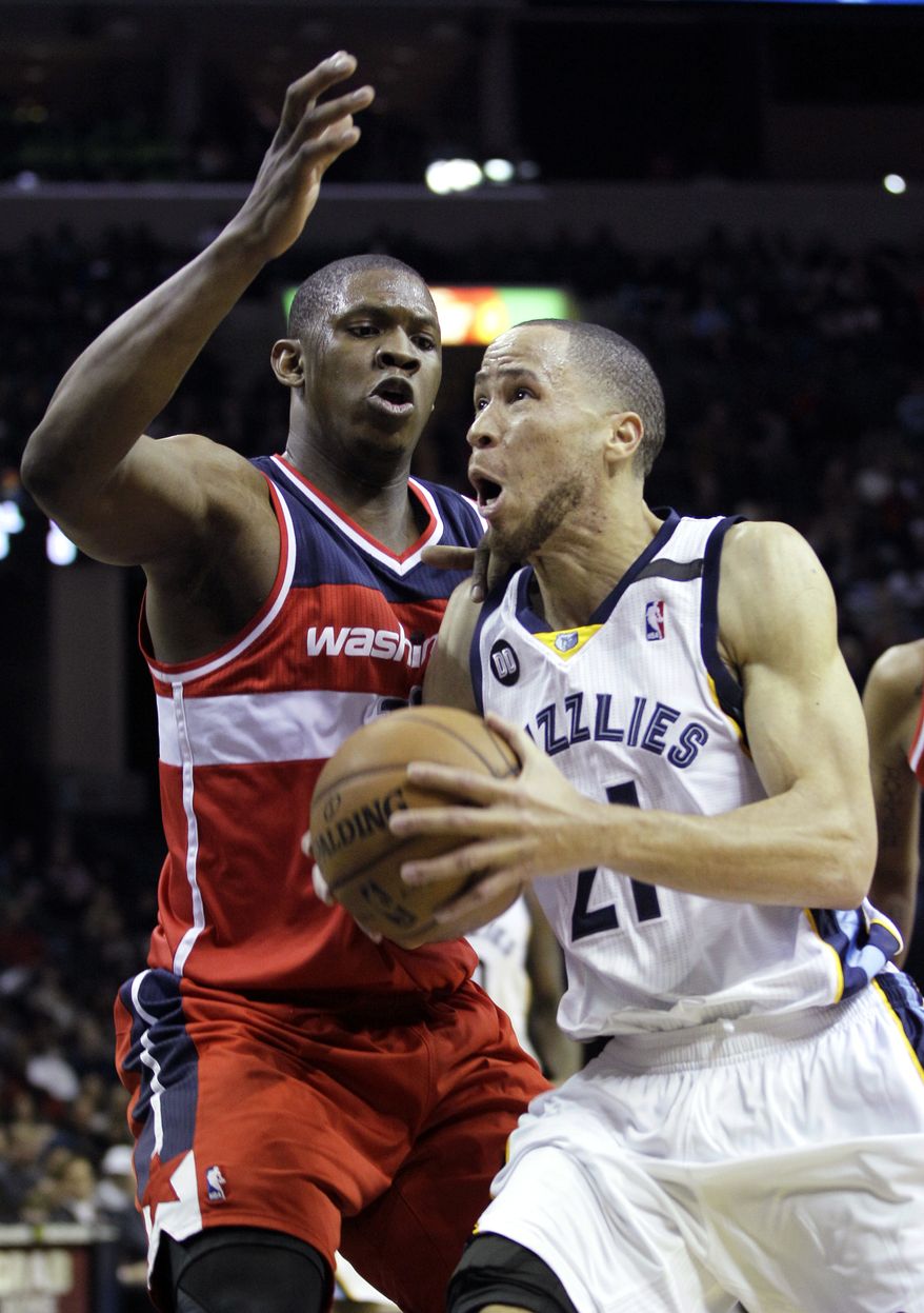 Washington Wizards' Kevin Seraphin, left, of France, defends against Memphis Grizzlies' Tayshaun Prince (21) during the second half of an NBA basketball game in Memphis, Tenn., Friday, Feb. 1, 2013. The Grizzlies defeated the Wizards 85-76. Prince, formerly of the Detroit Pistons, scored 14 points in his Grizzlies debute. (AP Photo/Danny Johnston)