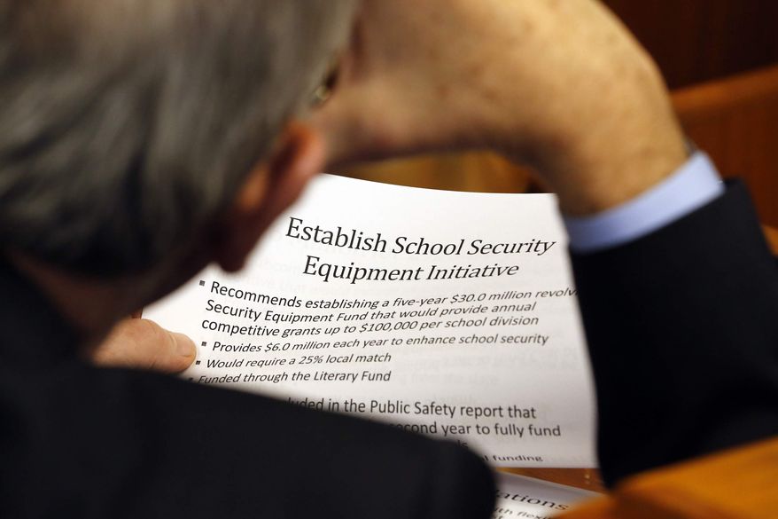 Del. Charles Poindexter (R-Patrick) looks over details of a house subcommittee recommendations on funding school security measures included in the House budget bill during a Sunday legislative session in Richmond, Feb. 3, 2013. (AP Photo/The Richmond Times-Dispatch, Joe Mahoney)