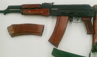 ** FILE ** An AK-47 assault rifle with a high capacity ammunition cartridge was confiscated during one of two undercover sting operations targeting gun traffickers in the Bronx borough of New York on Thursday, Jan. 24, 2013. (AP Photo/New York City Police Department)

