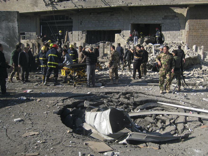 Iraqi civilians and security forces inspect a crater caused by a car bomb attack in Kirkuk, Iraq, 180 miles north of Baghdad, on Sunday, Feb. 3, 2013. (AP Photo/Emad Matti)