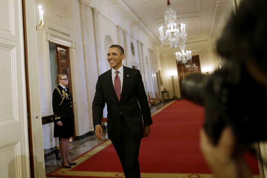 ** FILE ** President Barack Obama walks from the Cross Hall into the East Room of the White House in Washington, Friday, Feb. 1, 2013, to award the National Medal of Science and National Medal of Technology and Innovation to recipients at a ceremony. (AP Photo/Charles Dharapak)