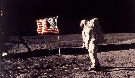 Astronaut Edwin E. &quot;Buzz&quot; Aldrin Jr.  poses for a photograph beside the U.S. flag deployed on the moon during the Apollo 11 mission on July 20, 1969.  (AP Photo/NASA/Neil A. Armstrong) ** FILE **