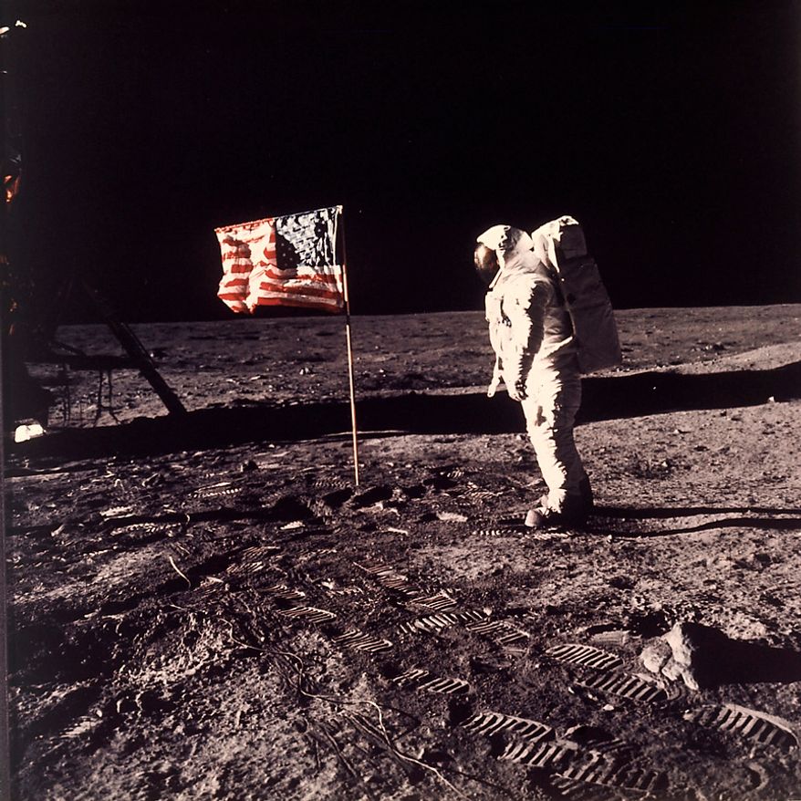 Astronaut Edwin E. "Buzz" Aldrin Jr. poses for a photograph beside the U.S. flag deployed on the moon during the Apollo 11 mission on July 20, 1969. (AP Photo/NASA/Neil A. Armstrong)
Conspiracy theorists have claimed that photos of the lunar landings are bogus due to: a lack of visible stars; inconsistent shadows and lighting that seem to track with a studio production; what looks like the letter “C†written on a moon rock and the lunar surface; an Australian woman’s alleged claim that she saw a soft drink bottle in the frame while watching one of the manned landings take place on live television. NASA has provided plausible explanations for all of the above: Stars weren’t visible due to the brightness of the sun during the lunar daytime; inconsistent shadows and lighting were the result of lens distortion, lunar dust, uneven ground and multiple light sources; the “C†shape does not appear in original lunar camera film and is believed to be a coiled hair that made its way into the printing processes