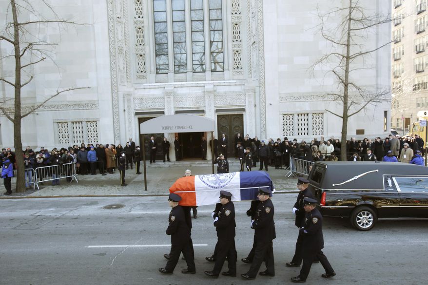 The casket containing the remains of former New York Mayor Ed Koch is carried by policemen into Temple Emanu-El for his funeral in New York on Monday, Feb. 4, 2013. Mr. Koch died Friday of congestive heart failure at age 88. (AP Photo/Seth Wenig)
