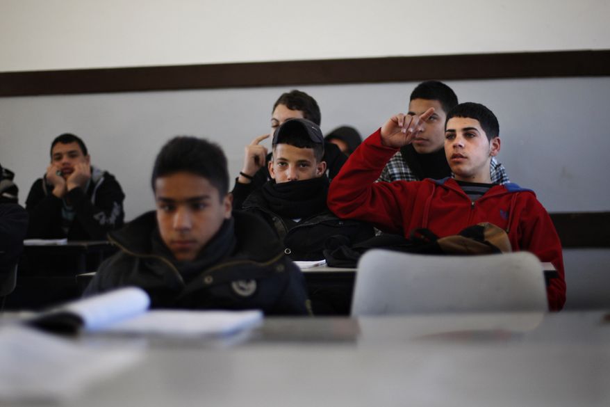 Palestinian students attend class in a school in the West Bank city of Ramallah on Sunday, Feb. 3, 2013. (AP Photo/Majdi Mohammed)