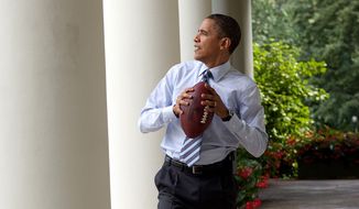 President Obama gets ready to toss a football in this photo posted on his Twitter feed moments before the Super Bowl kickoff between the Ravens and 49ers. It was taken in 2010. ** FILE **