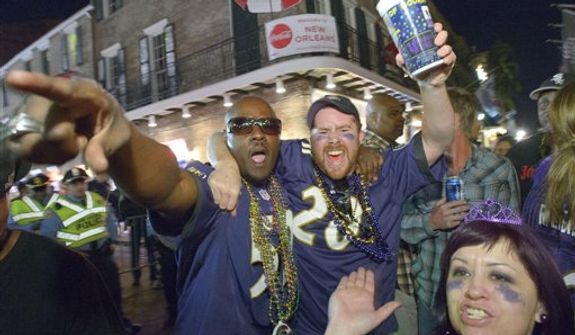Baltimore Ravens fans celebrate the team&#39;s victory as fans from the Ravens and San Francisco 49ers NFL football teams pack the French Quarter on Bourbon Street for Super Bowl XLVII in New Orleans, Sunday, Feb. 3, 2013. (AP Photo/Matthew Hinton)