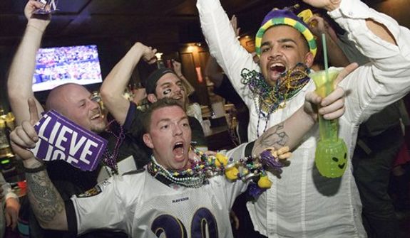 Lee Fuller, of Baltimore, center, and others celebrate the Baltimore Ravens winning the Super Bowl at the Famous Door Bar as fans of the Ravens and San Francisco 49ers NFL football teams pack the French Quarter on Bourbon Street for Super Bowl XLVII in New Orleans, Sunday, Feb. 3, 2013. (AP Photo/Matthew Hinton)
