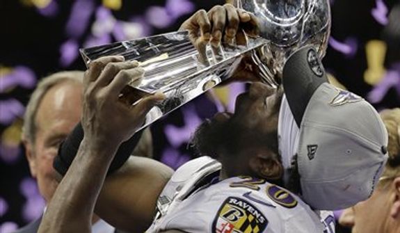 Baltimore Ravens safety Ed Reed (20) holds up the Vince Lombardi Trophy after defeating the San Francisco 49ers 34-31 in the NFL Super Bowl XLVII football game Sunday, Feb. 3, 2013, in New Orleans. (AP Photo/Julio Cortez) 