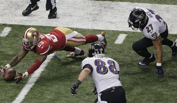 San Francisco 49ers cornerback Tarell Brown (25) recovers a fumble by Baltimore Ravens running back Ray Rice (27) as tight end Dennis Pitta (88) closes in during the second half of the NFL Super Bowl XLVII football game, Sunday, Feb. 3, 2013, in New Orleans. (AP Photo/Charlie Riedel)