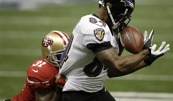 Baltimore Ravens tight end Ed Dickson (84) makes a catch against San Francisco 49ers safety Donte Whitner (31) during the first half of NFL Super Bowl XLVII football game, Sunday, Feb. 3, 2013, in New Orleans. (AP Photo/Elaine Thompson)