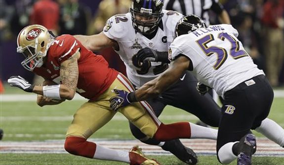 San Francisco 49ers quarterback Colin Kaepernick (7) is tackled by Baltimore Ravens defensive end Haloti Ngata (92) and linebacker Ray Lewis (52) in the first quarter of the NFL Super Bowl XLVII football game, Sunday, Feb. 3, 2013, in New Orleans. (AP Photo/Dave Martin)
