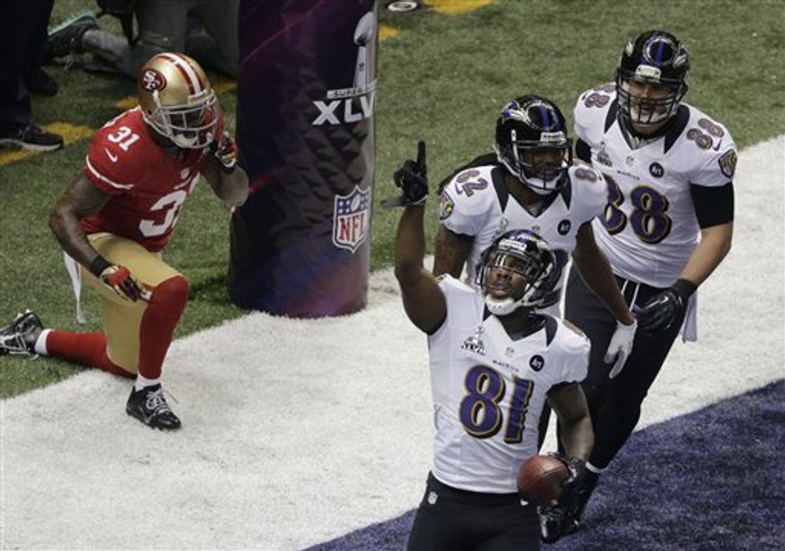 Baltimore Ravens wide receiver Anquan Boldin (81) celebrates his 13-yard touchdown reception with teammates Torrey Smith (82) and Dennis Pitta (88) as San Francisco 49ers safety Donte Whitner (31) recovers during the first half of the NFL Super Bowl XLVII football game, Sunday, Feb. 3, 2013, in New Orleans. (AP Photo/Charlie Riedel)