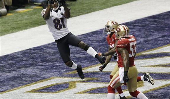 Baltimore Ravens wide receiver Anquan Boldin (81) catches a pass for a touchdown as San Francisco 49ers linebacker NaVorro Bowman (53)  and teammate Donte Whitner trail the play during the first half of the NFL Super Bowl XLVII football game Sunday, Feb. 3, 2013, in New Orleans. (AP Photo/Gerald Herbert)