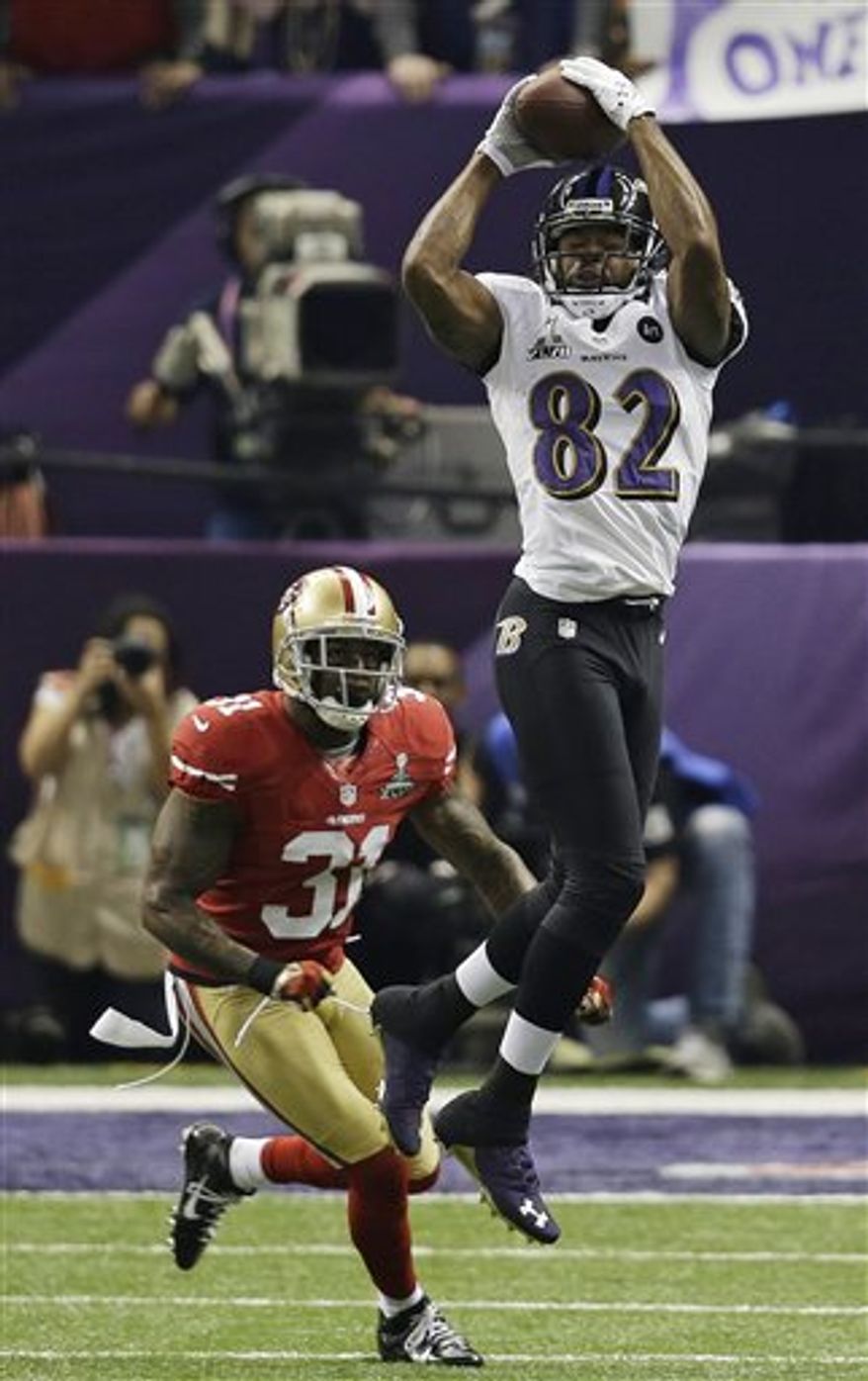 Baltimore Ravens wide receiver Torrey Smith (82) makes a catch against San Francisco 49ers safety Donte Whitner (31) during the first half of the NFL Super Bowl XLVII football game, Sunday, Feb. 3, 2013, in New Orleans. (AP Photo/Elaine Thompson)