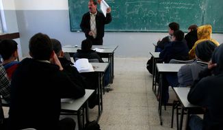 Palestinian students attend class in a Ramallah, West Bank, school Sunday. A U.S.-funded study released Monday said both Israeli and Palestinian schoolbooks largely present one-sided narratives of the two sides&#39; conflict. (Associated Press)