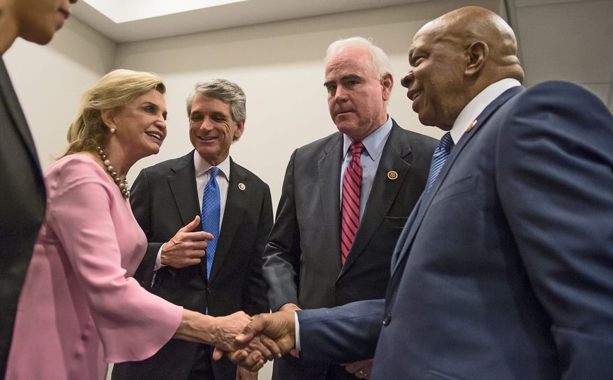Reps. Carolyn B. Maloney (from left), New York Democrat; E. Scott Rigell, Virginia Republican; Patrick Meehan, Pennsylvania Republican; and Elijah E. Cummings, Maryland Democrat, prepare Tuesday to announce legislation to make firearms trafficking a federal crime and stiffen laws against straw buyers. (Andrew Harnik/The Washington Times)