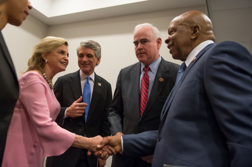 From left: Reps. Carolyn Maloney, New York Democrat, Scott Rigell, Virginia Republican, Patrick Meehan, Pennsylvania Republican, and Elijah Cummings, Maryland Democrat, great each other before a press conference Feb. 5, 2013, in Washington to introduce the first bipartisan bill in the House of Representatives during the 113th Congress, which would make firearms trafficking a federal crime and impose stronger penalties for straw purchasers who buy guns for convicted felons and others who are prohibited from buying guns on their own. (Andrew Harnik/The Washington Times)
