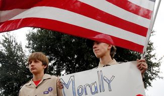 ** FILE ** Stephen Cyr (left), 13, and his brother Paul, 15, attend a &quot;Save Our Scouts&quot; prayer vigil and rally in front of the Boy Scouts of America national headquarters in Texas on Feb. 6, 2013. (Associated Press)