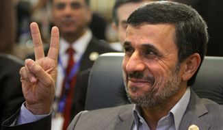 ** FILE ** Iranian President Mahmoud Ahmadinejad flashes the victory sign as he attends the 12th summit of the Organization of Islamic Cooperation in Cairo on Wednesday, Feb. 6, 2013. (AP Photo/Amr Nabil)