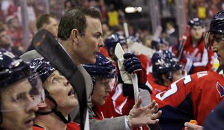 Washington Capitals coach Adam Oates leans to speak with left wing Alex Ovechkin, right, during a timeout in the third period of an NHL hockey game against the Toronto Maple Leafs on Tuesday, Feb. 5, 2013, in Washington. The Maple Leafs won 3-2. (AP Photo/Alex Brandon)