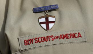 ** FILE ** This photo taken Monday, Feb. 4, 2013, shows a close up detail of a Boy Scout uniform worn by Brad Hankins, a campaign director for Scouts for Equality, as he responds to questions during a news conference in front of the Boy Scouts of America headquarters in Irving, Texas. (AP Photo/Tony Gutierrez)

