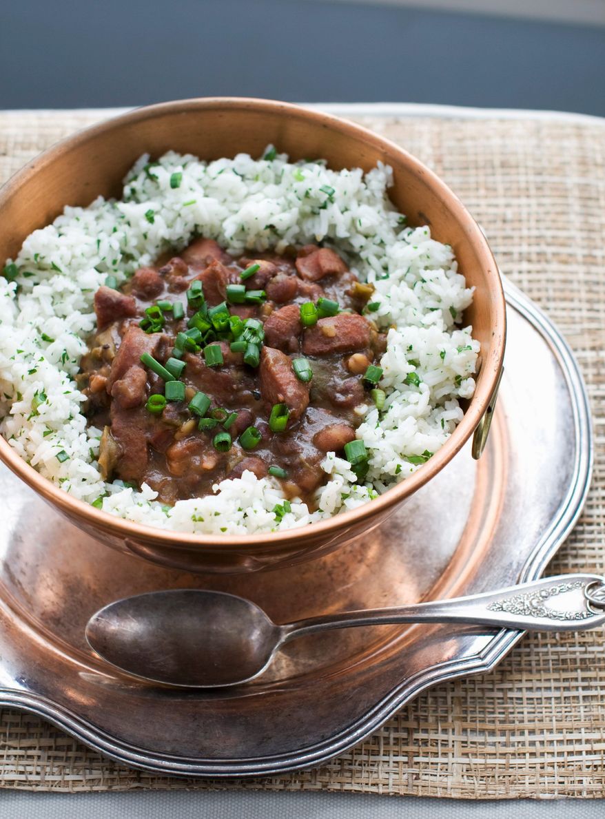 This stewlike red beans and rice menu uses smoked pork hock, andouille sausage and salt pork. (Associated Press)