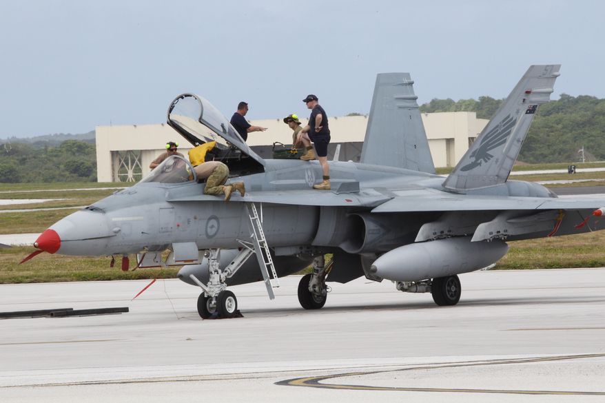 An Australian fighter jet is readied for a training mission at the Cope North military exercises at Andersen Air Force Base on the U.S. island of Guam, Thursday, Feb. 7, 2013. Fighter jets from the U.S. and two key allies roared into Western Pacific skies Thursday in the combat phase of exercises that have gained importance as the region responds to the rise of China and other potential threats. (AP Photo/Eric Talmadge)