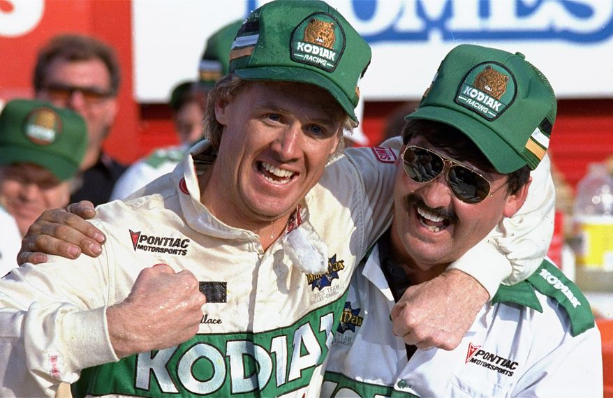 **FILE** In this Oct. 10, 1988, file photo, NASCAR driver Rusty Wallace of St. Louis, Mo., left, hugs his crew chief Barry Dodson in victory lane after winning the Oakwood Homes 500 auto race at the Charlotte Motor Speedway in Concord, N.C. Wallace, a winner of 55 races and the 1989 championship, will be inducted Friday night, Feb. 8, 2013, into the NASCAR Hall of Fame, along with Buck Baker and Herb Thomas; car owner Cotton Owens and crew chief, mechanic and engine builder Leonard Wood. (AP Photo/Robert Willett, File)