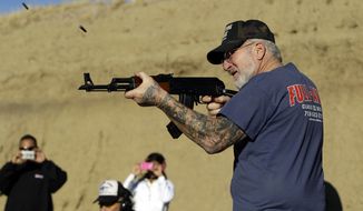 **FILE** Gun dealer Mel Bernstein fires his AK-47 assault rifle on full automatic at his own Dragonman&#39;s shooting range and gun store, east of Colorado Springs, Colo., on Feb. 5, 2013. (Associated Press)