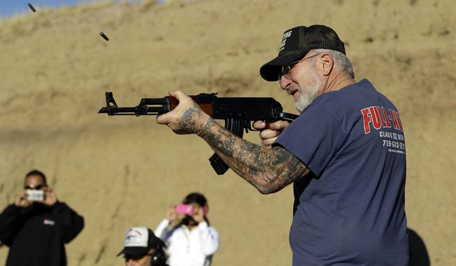 **FILE** Gun dealer Mel Bernstein fires his AK-47 assault rifle on full automatic at his own Dragonman&#x27;s shooting range and gun store, east of Colorado Springs, Colo., on Feb. 5, 2013. (Associated Press)