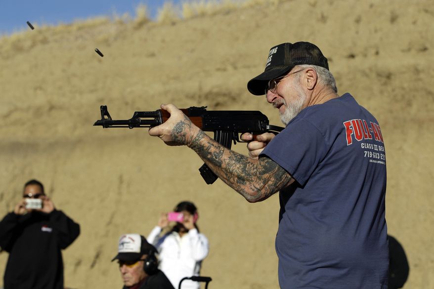 **FILE** Gun dealer Mel Bernstein fires his AK-47 assault rifle on full automatic at his own Dragonman's shooting range and gun store, east of Colorado Springs, Colo., on Feb. 5, 2013. (Associated Press)