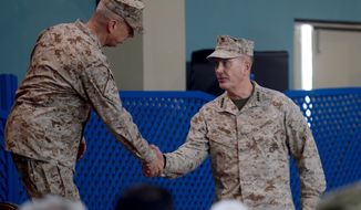 U.S. Marine Gen. Joseph F. Dunford (right) shakes hands with U.S. Marine Gen. John Allen (left), the outgoing NATO commander, during a change-of-command ceremony at the International Security Assistance Force headquarters in Kabul, Afghanistan, on Sunday, Feb. 10, 2013. Gen. Dunford takes charge at a critical time for President Obama and the military as foreign combat forces prepare to withdraw from Afghanistan by the end of 2014. (AP Photo/Massoud Hossaini, Pool)