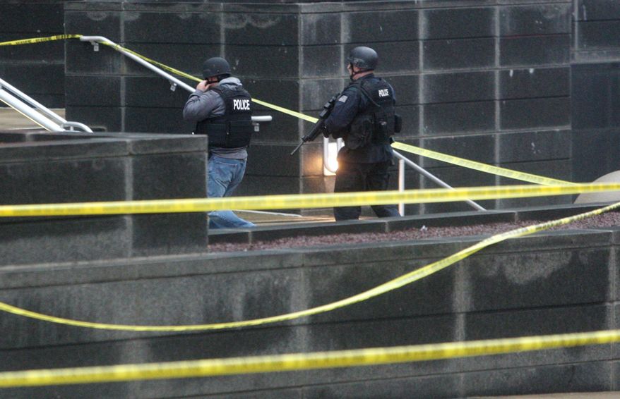 Heavily armed police enter the New Castle County Courthouse, Monday morning, Feb. 11, 2013, in Wilmington, Del. The mayor of Wilmington, Del., says a man suspected of killing his wife and wounding two others at the New Castle County Courthouse has been killed by police. (AP Photo/The News Journal/William Bretzger)