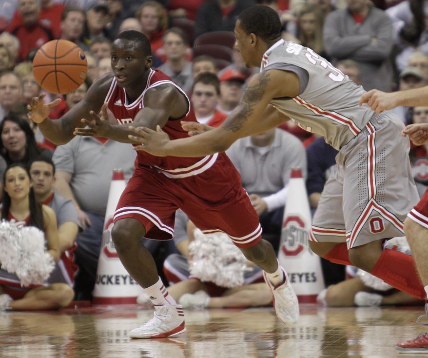 Indiana's Victor Oladipo, left, grabs a loose ball away from Ohio State's Lenzelle Smith during the second half of an NCAA college basketball game on Sunday, Feb. 10, 2013, in Columbus, Ohio. Indiana defeated Ohio State 81-68. (AP Photo/Jay LaPrete)