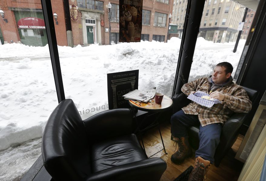 Matt Church enjoys his breakfast at a coffee shop in downtown Haverhill, Mass., on Monday, Feb. 11, 2013. Beleaguered Massachusetts residents returned to work on Monday for the first time since the weekend blizzard, crawling along narrow snow-covered secondary roads and being greeted by a new wintry mix of sleet and freezing rain. (AP Photo/Elise Amendola)