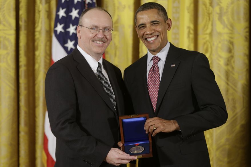 **FILE** President Obama awards the National Medal of Technology and Innovation to Raytheon BBN Technologies, accepted by CEO Edward Campbell on Feb. 1, 2013, during at a ceremony in the East Room of the White House in Washington. The awards are the highest honors bestowed by the U.S. government upon scientists, engineers, and inventors. (Associated Press)