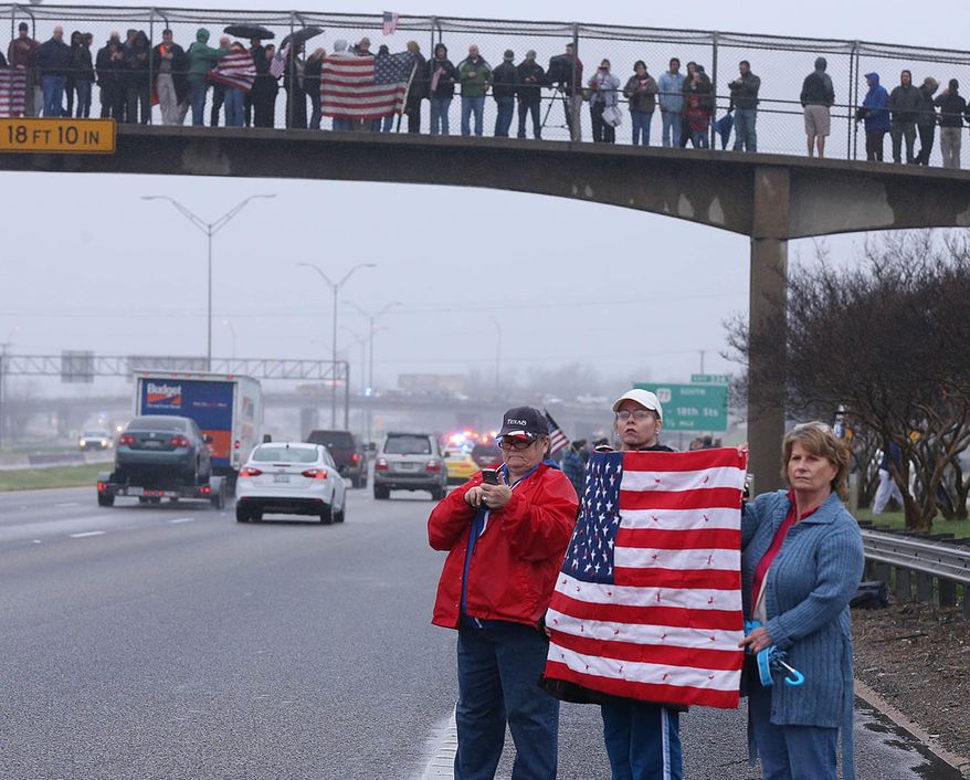Supports of Chris Kyle in Midlothian, Texas, line up along the southbound lane of Interstate 35, Tuesday, Feb. 12, 2013, in Waco, Texas, for his final journey to Austin, where he will be buried at the Texas State Cemetery. Kyle and his friend Chad Littlefield were shot and killed Feb 2. at a North Texas gun range. (AP Photo/Waco Tribune Herald, Rod Aydelotte)