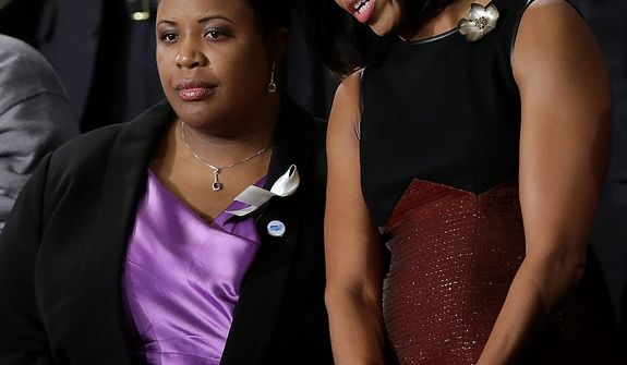 First lady Michelle Obama stands with Cleopatra Cowley-Pendelton before President Barack Obama&#39;s State of the Union address during a joint session of Congress on Capitol Hill in Washington, Tuesday Feb. 12, 2013. (AP Photo/Pablo Martinez Monsivais)
