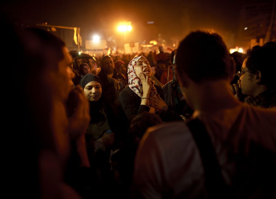 An Egyptian woman chants slogans in Tahrir Square in Cairo on Friday, Jan. 25, 2013, two years after the uprising that ousted President Hosni Mubarak. (AP Photo/Maya Alleruzzo)
