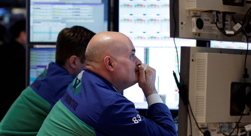 Specialist Anthony Confusione (right) works at his post on the floor of the New York Stock Exchange on Thursday. The stock market recently surged to five-year highs. Many small investors remain skittish, however. (Associated Press)
