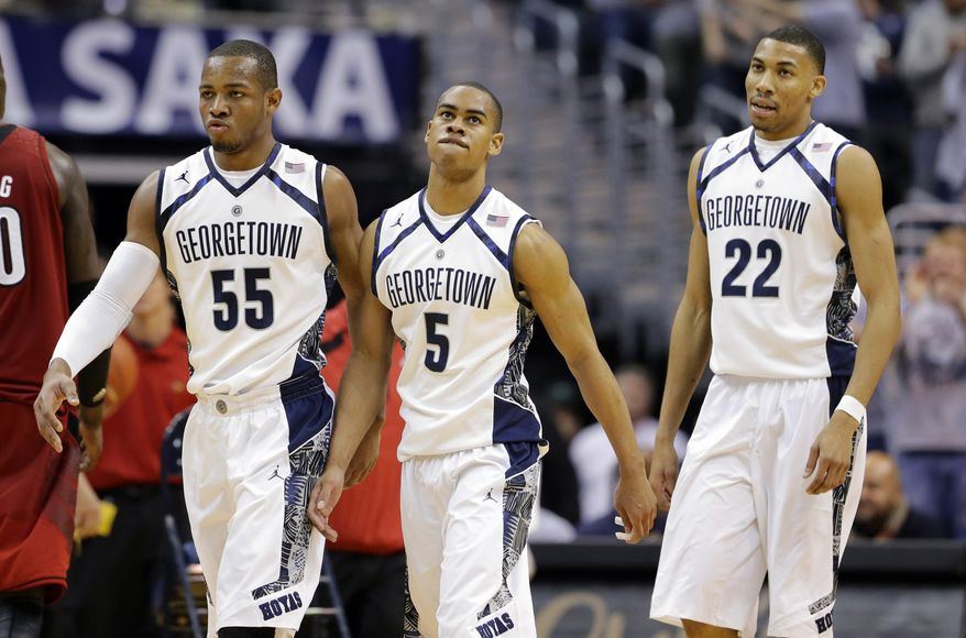 **FILE** In this Jan. 26, 2013, file photo, Georgetown guard Jabril Trawick (55), guard Markel Starks (5) and forward Otto Porter Jr. (22) walk to the bench during a timeout during the second half of an NCAA college basketball game against Louisville in Washington. Georgetown coach John Thompson III does such a good job selling his team-orientated system that sometimes his best players don't assert themselves the way they should. In recent games, the light bulb has come on for Porter and Starks, and that's why the Hoyas are contending for a Big East title. (AP Photo/Alex Brandon, File)